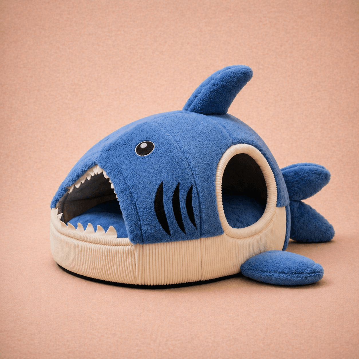 Blue plush shark-shaped cave dog bed with open mouth entrance
