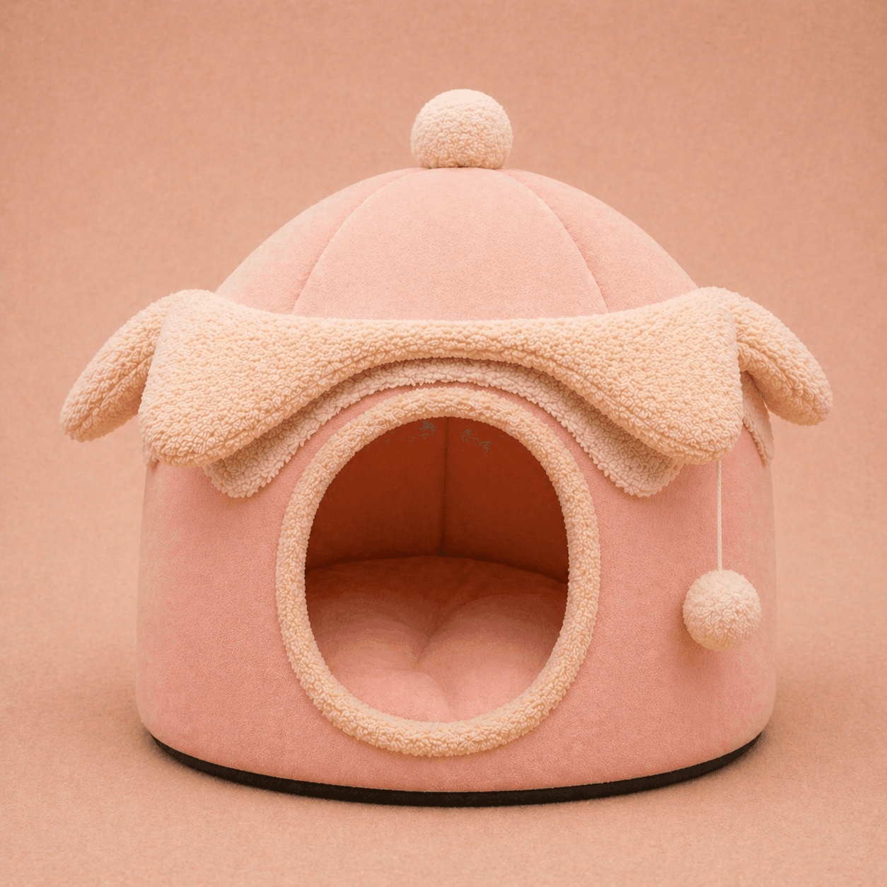 Pink felt dome cave dog bed with ear and pom-pom details